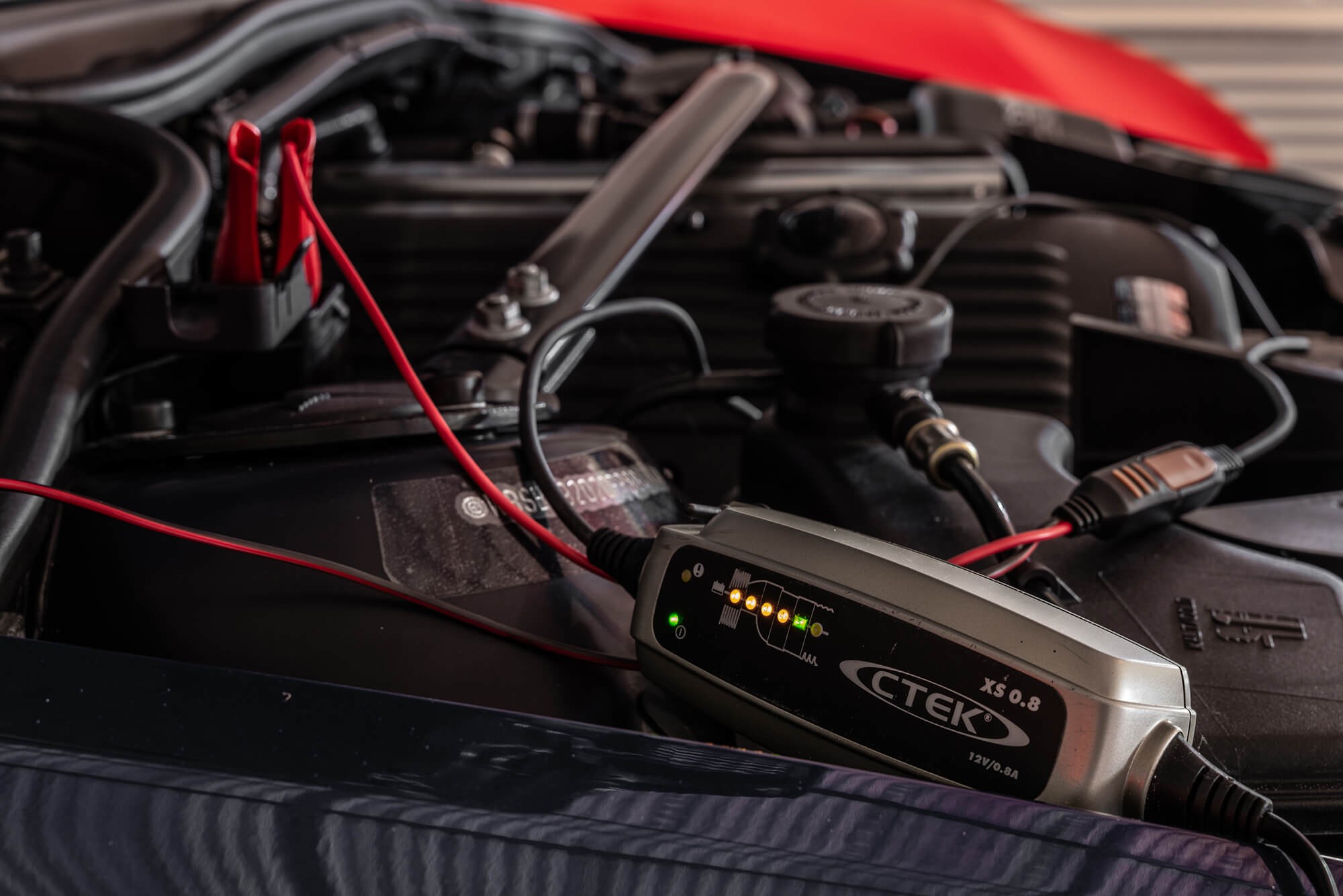 Stored car connected to a battery trickle charger