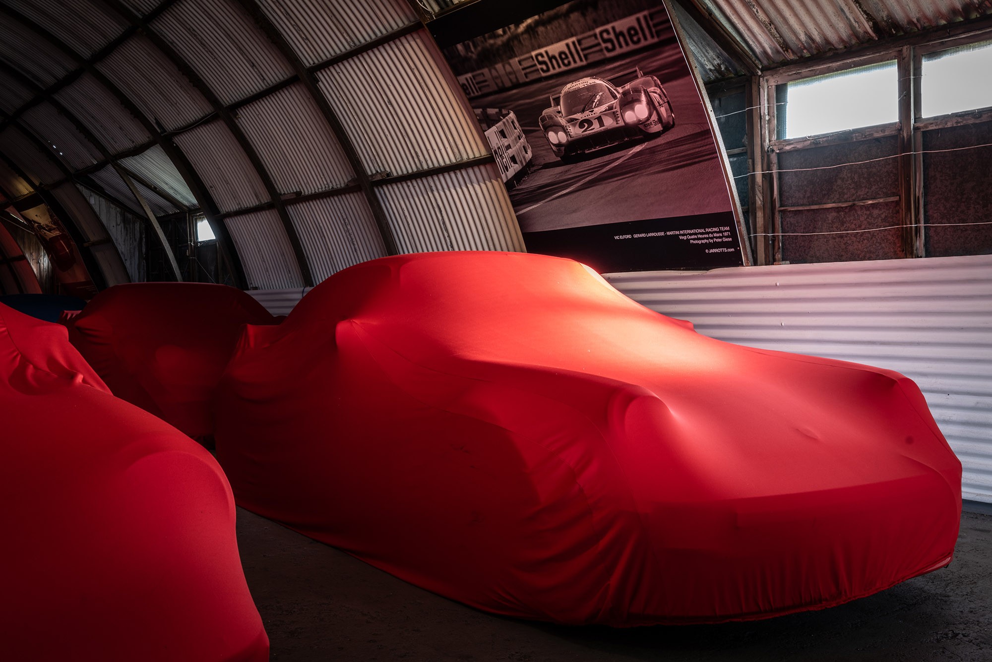 Car in storage under a dust sheet