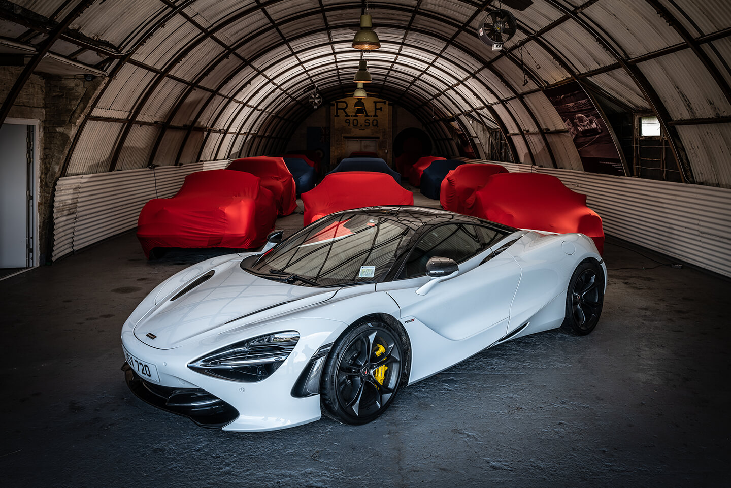 A Mclaren F1, with rows of covered cars behind. An example of the presitge cars stored at Ecurie 137